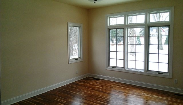 7507 Kishwaukee Road Stillman Valley, IL 61084 - Photo 7 of 20 a view of an empty room with wooden floor and a window