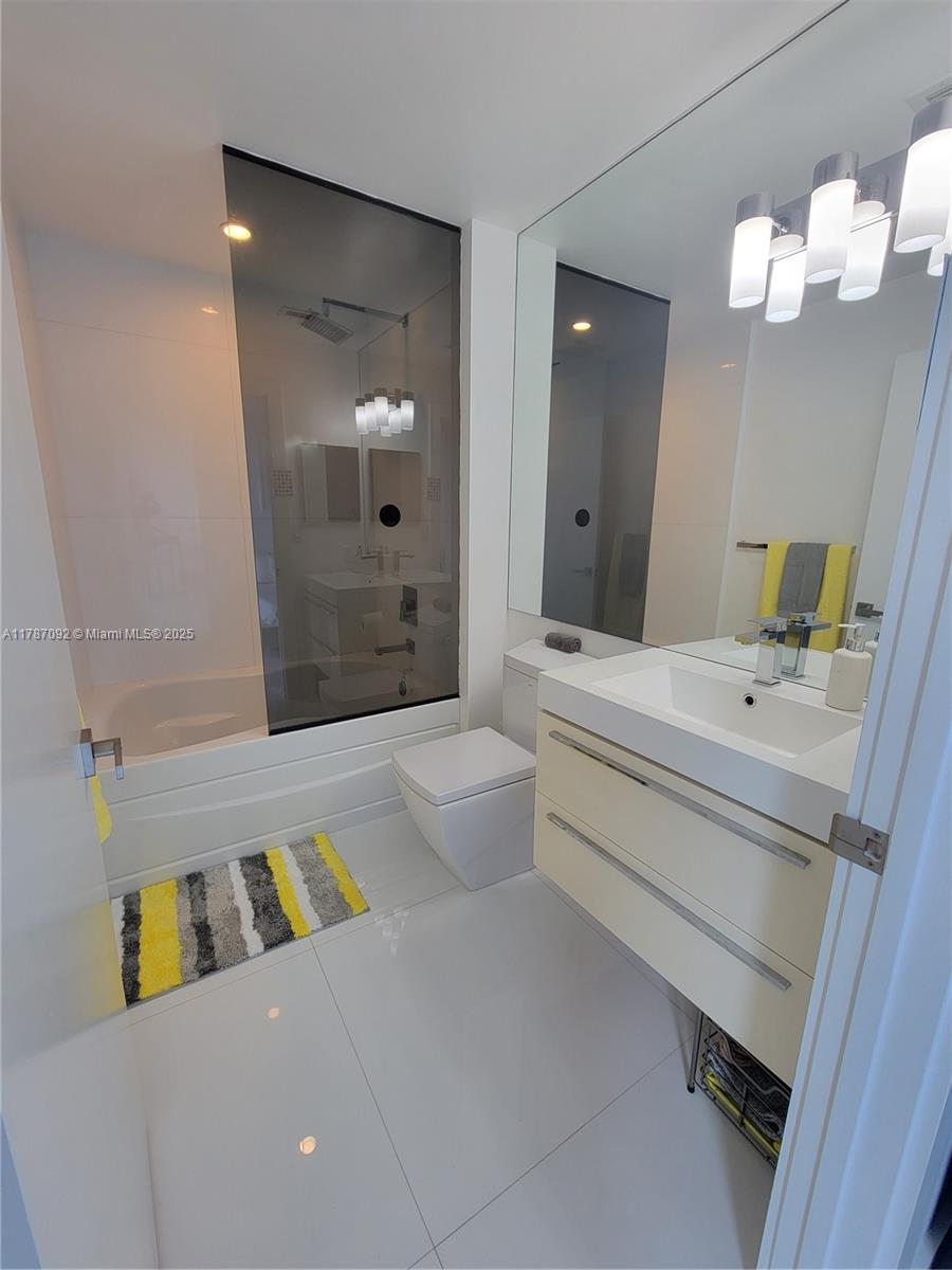 90 Alton Road, Unit 1 Miami Beach, FL 33139 - Photo 19 of 36 a bathroom with a sink a toilet and shower