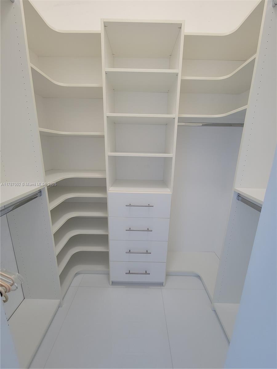 90 Alton Road, Unit 1 Miami Beach, FL 33139 - Photo 23 of 36 a view of walk in closet with empty racks
