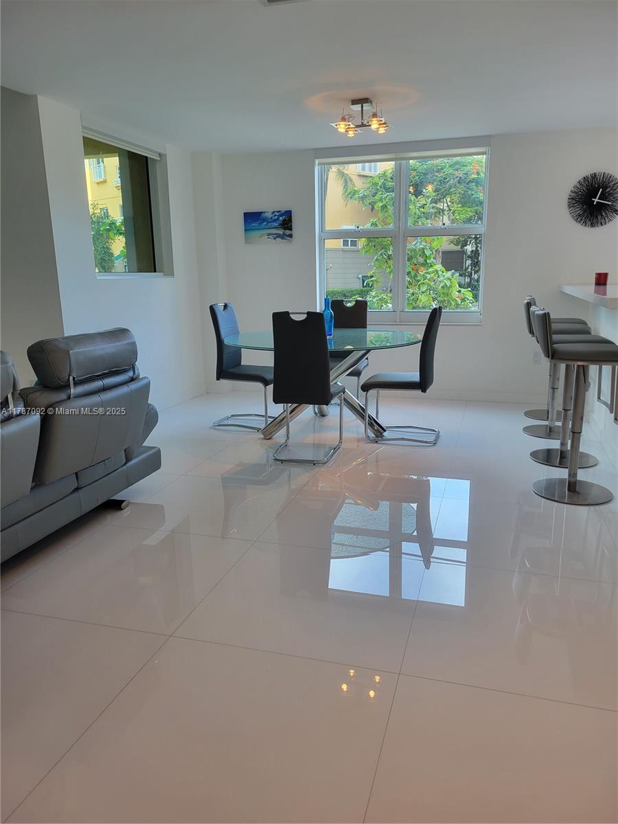 90 Alton Road, Unit 1 Miami Beach, FL 33139 - Photo 5 of 36 a living room with furniture and a large window