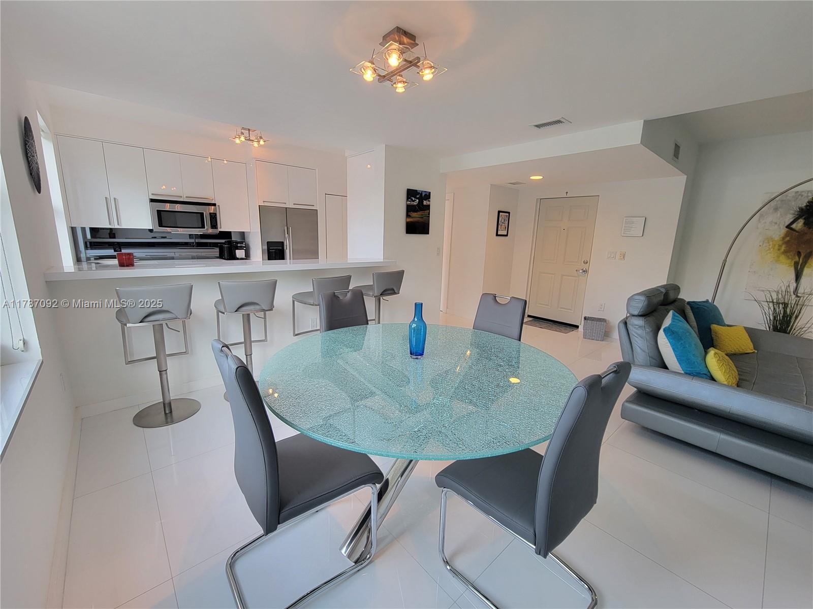 90 Alton Road, Unit 1 Miami Beach, FL 33139 - Photo 7 of 36 a view of a dining room with furniture