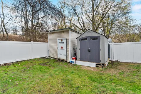 a view of a backyard with a large tree