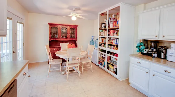 a bedroom with a bed and a mirror on dresser