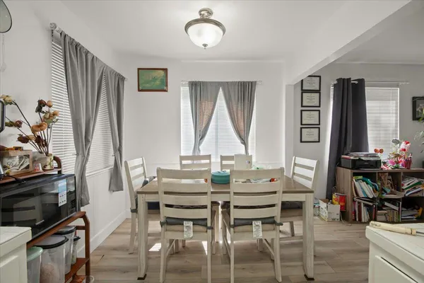 a view of a dining room with furniture and window