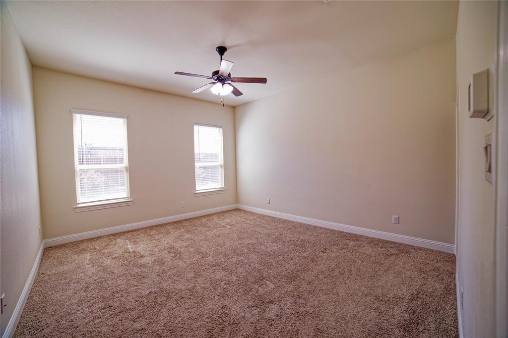 10929 Calvert Place McKinney, TX 75071 - Photo 21 of 39 an empty room with windows and fan