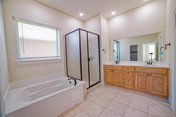 a spacious bathroom with a large tub shower and sink