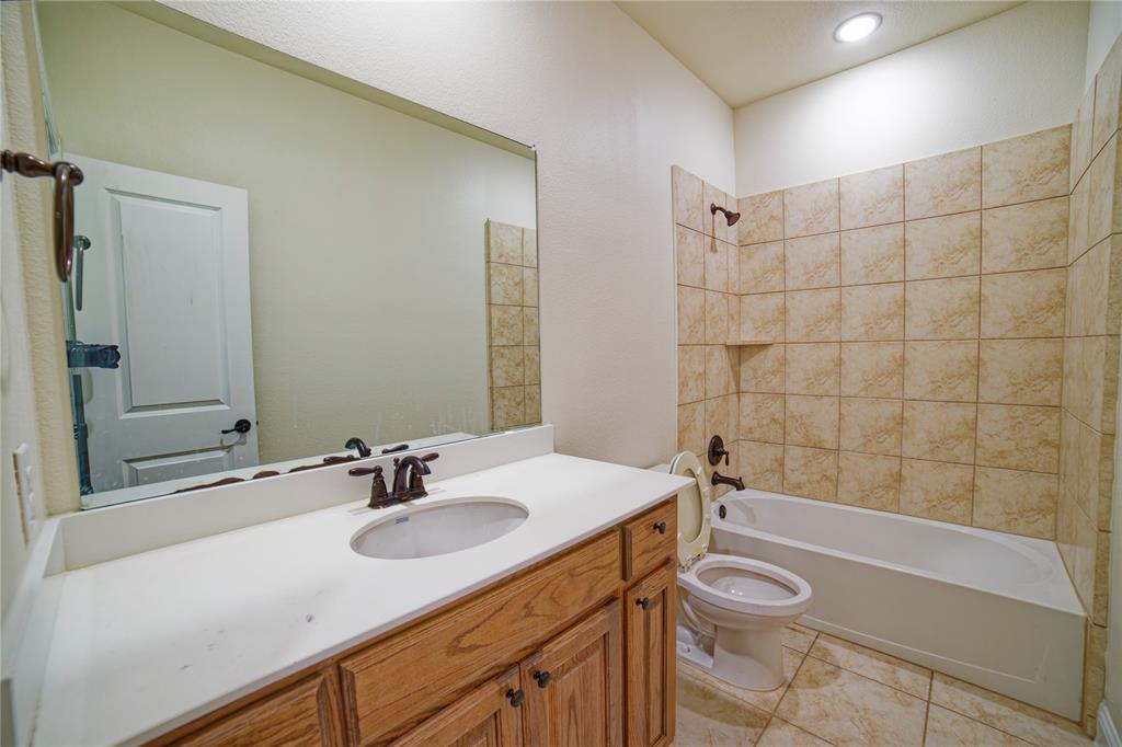 10929 Calvert Place McKinney, TX 75071 - Photo 28 of 39 a bathroom with a sink a toilet and shower