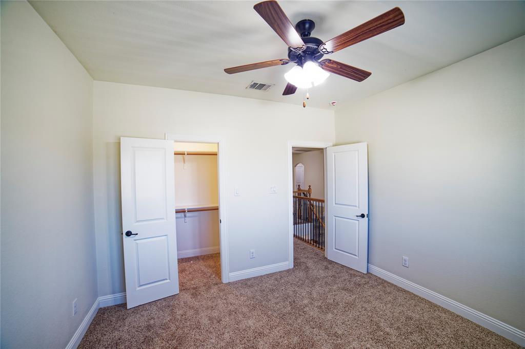 10929 Calvert Place McKinney, TX 75071 - Photo 37 of 39 an empty room with closet and a ceiling fan