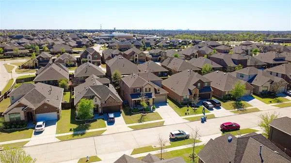 an aerial view of a houses with a swimming pool
