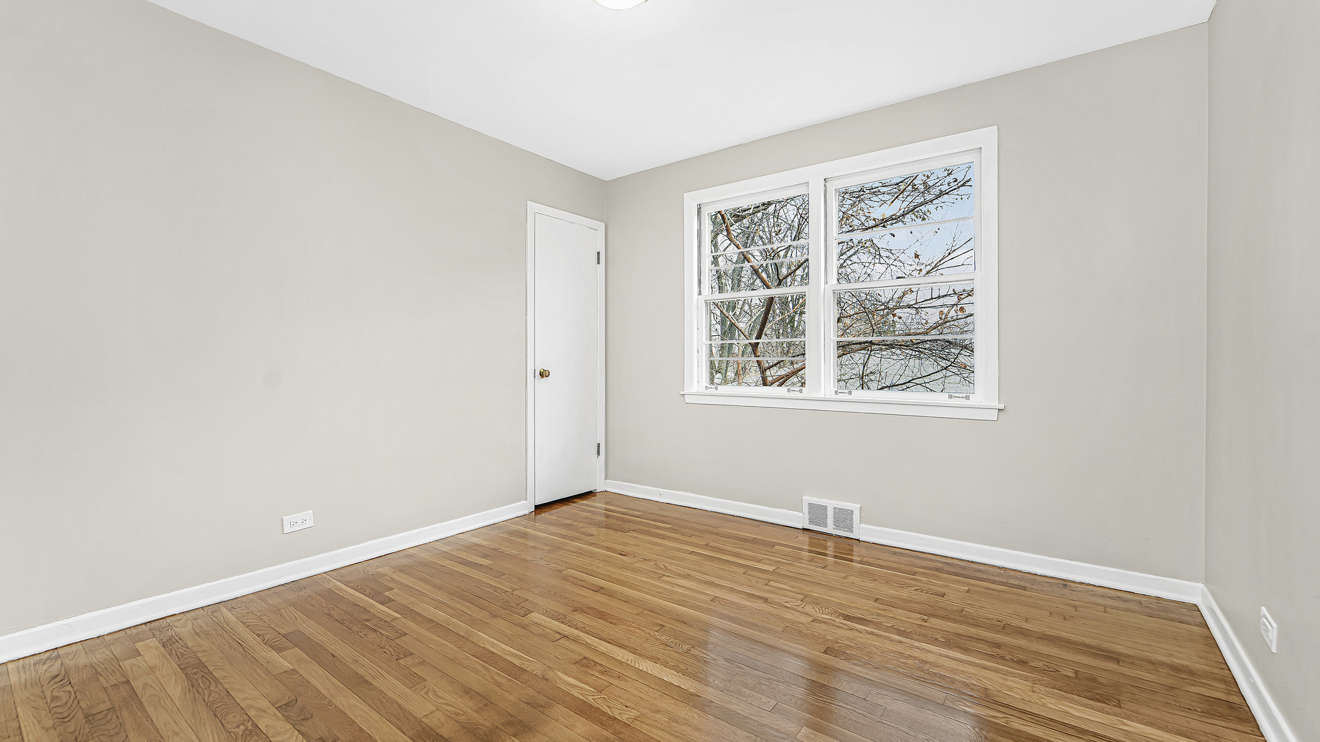 1314 Pitner Avenue Evanston, IL 60201 - Photo 11 of 19 an empty room with wooden floor and windows