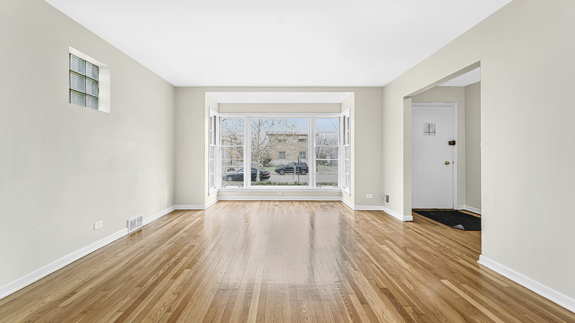 1314 Pitner Avenue Evanston, IL 60201 - Photo 3 of 19 a view of an empty room with wooden floor and a window