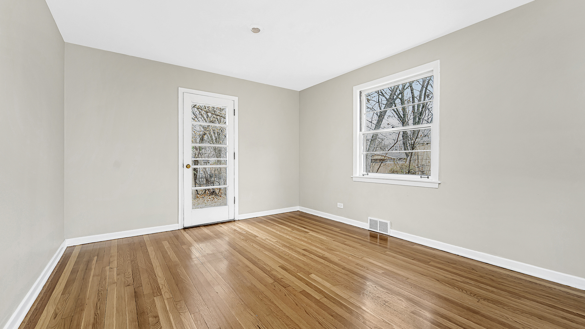 1314 Pitner Avenue Evanston, IL 60201 - Photo 6 of 19 an empty room with wooden floor and windows