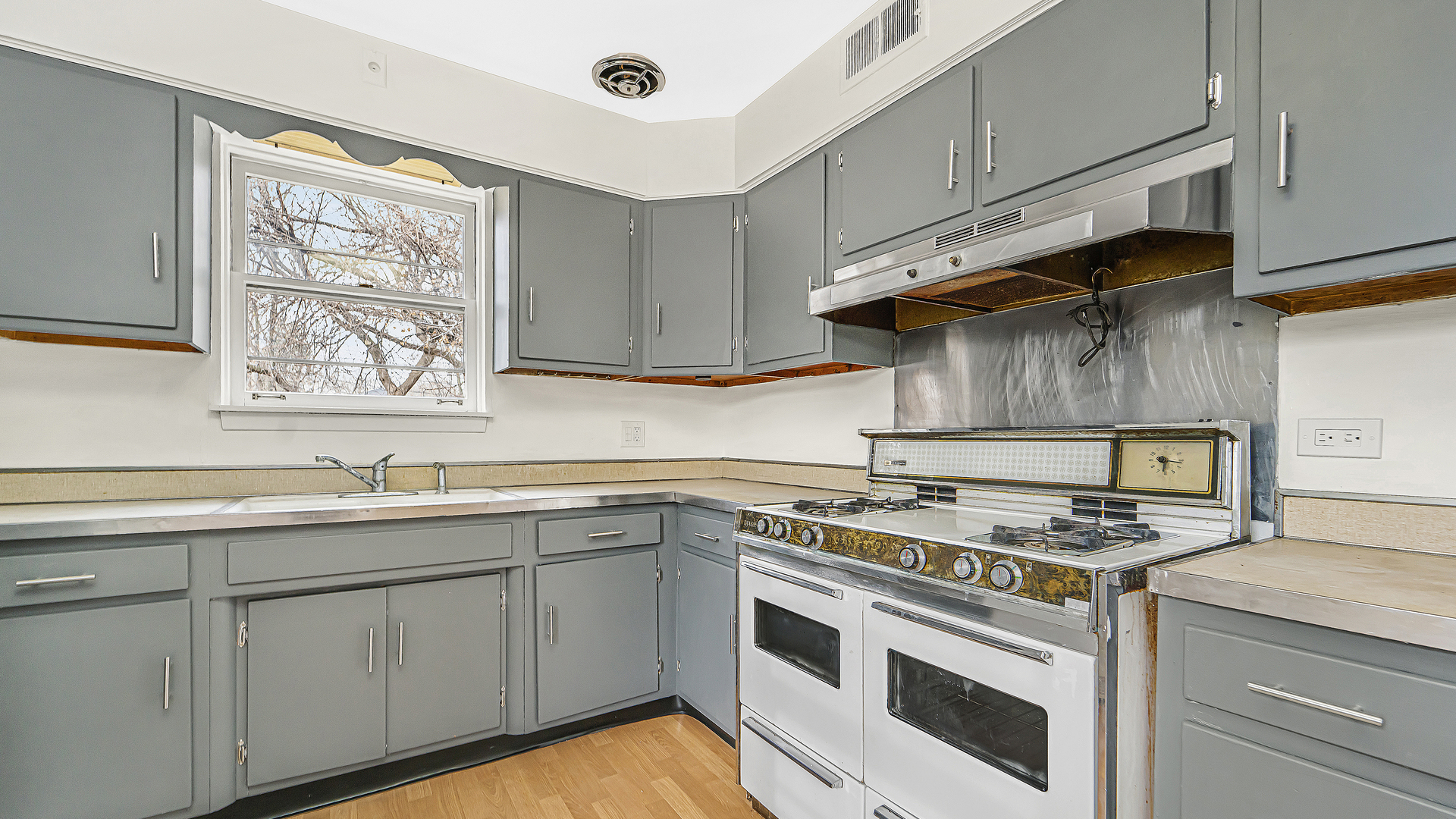1314 Pitner Avenue Evanston, IL 60201 - Photo 7 of 19 a kitchen with stainless steel appliances granite countertop a sink stove and cabinets