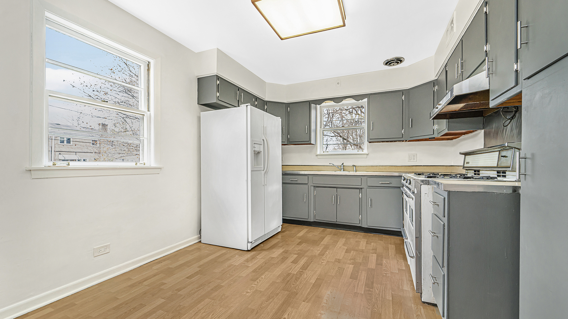 1314 Pitner Avenue Evanston, IL 60201 - Photo 8 of 19 a kitchen with a sink a refrigerator and window
