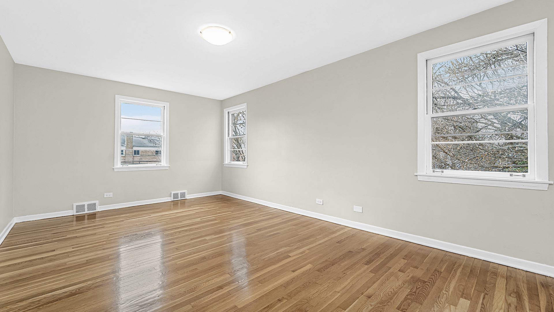 1314 Pitner Avenue Evanston, IL 60201 - Photo 10 of 19 a view of an empty room with wooden floor and a window