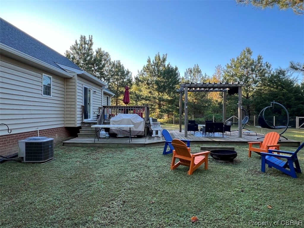 108 Hill Crest Road Wake, VA 23176 - Photo 20 of 21 View of yard featuring a wooden deck, a pergola, and central AC unit