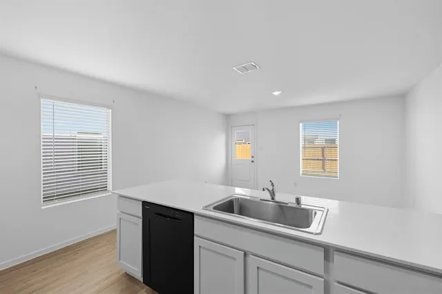 a kitchen with a sink and cabinets
