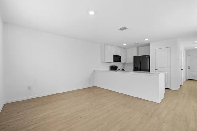 a view of a kitchen with microwave and cabinets
