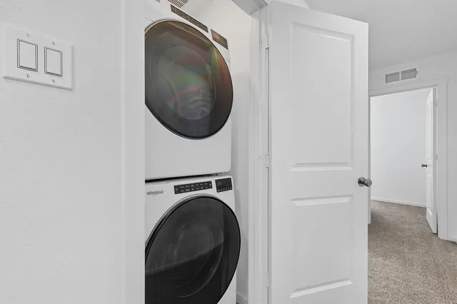 a close view of a utility room with dryer and washer