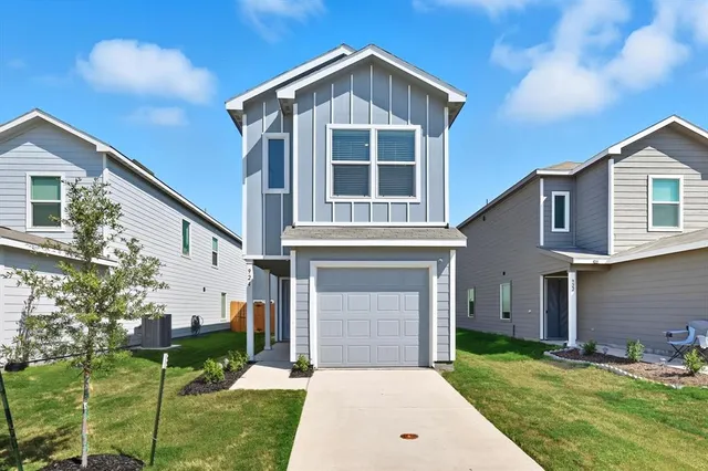 a front view of a house with a yard and garage