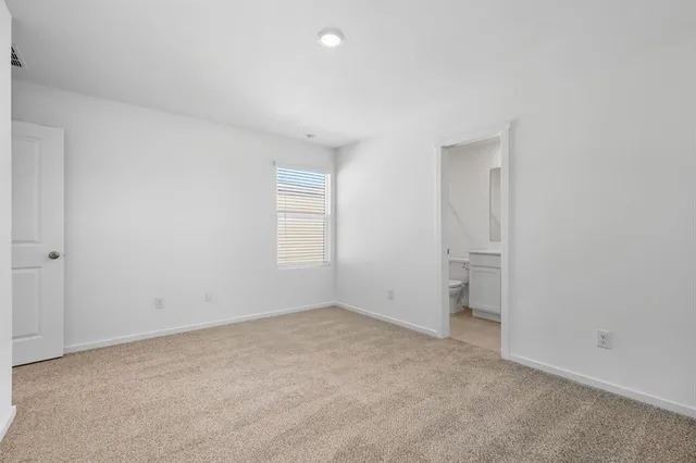 a view of an empty room and a window