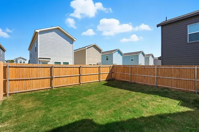 a view of a backyard with a fence