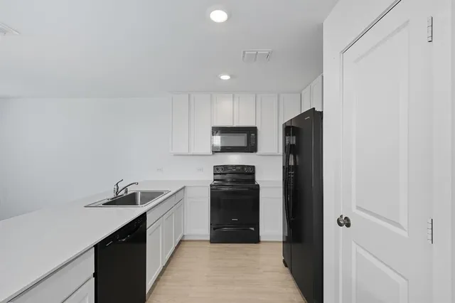 a kitchen with a refrigerator a sink and dishwasher