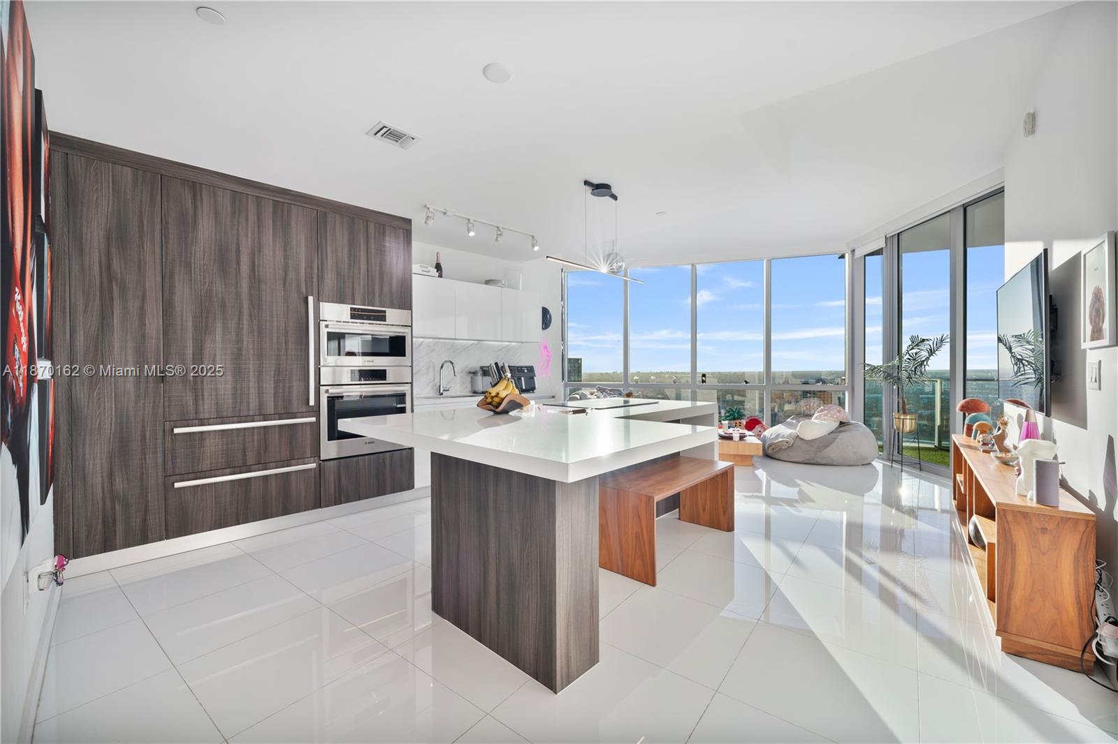 a kitchen with stainless steel appliances kitchen island granite countertop a refrigerator and a sink