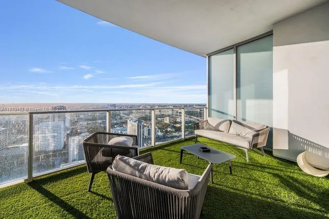 a view of a balcony with furniture