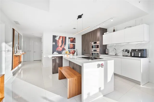 a kitchen that has a lot of cabinets in it and appliances