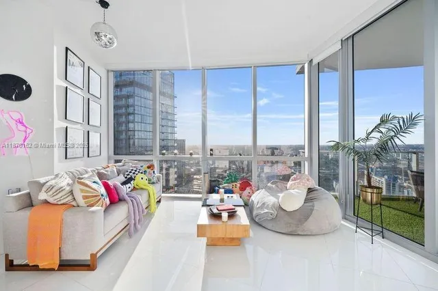 a bedroom with furniture and a large window