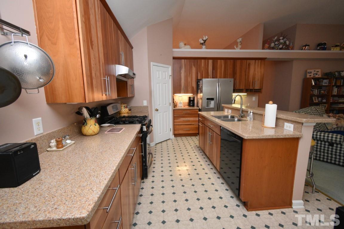 9904 Wyngate Ridge Drive Raleigh, NC 27617 - Photo 13 of 39 a kitchen with stainless steel appliances granite countertop a sink stove and refrigerator