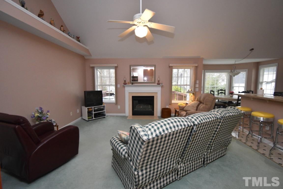9904 Wyngate Ridge Drive Raleigh, NC 27617 - Photo 16 of 39 a living room with furniture a fireplace and a flat screen tv