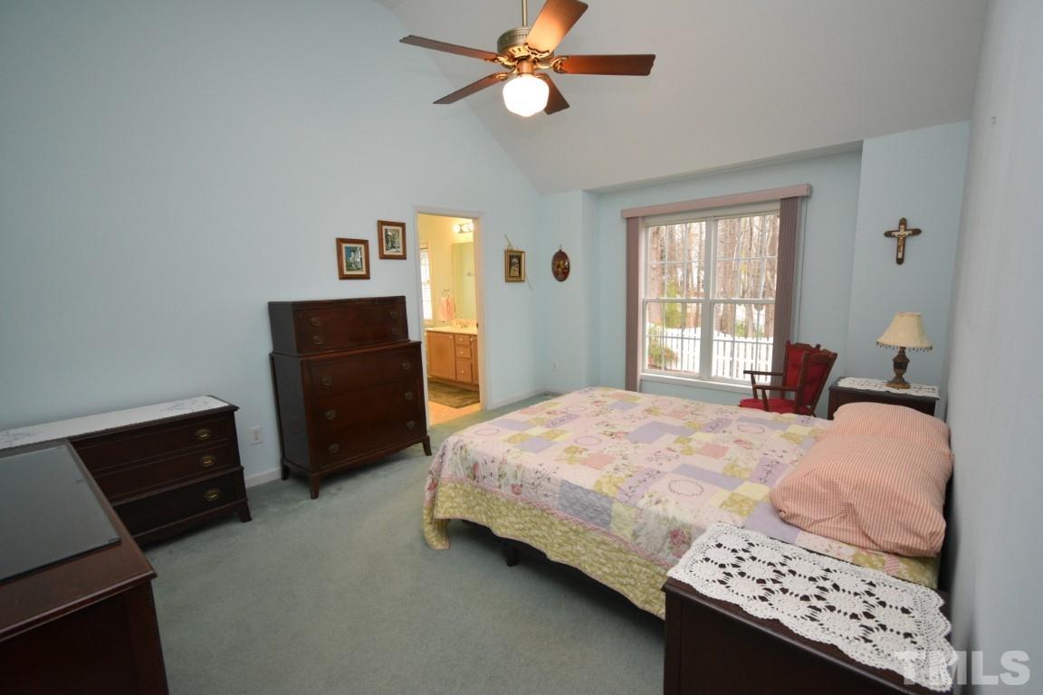 9904 Wyngate Ridge Drive Raleigh, NC 27617 - Photo 23 of 39 a bedroom with a bed and a dresser