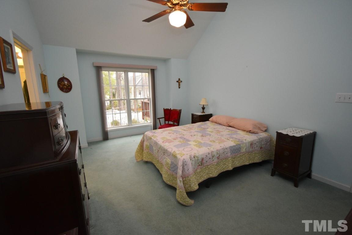 9904 Wyngate Ridge Drive Raleigh, NC 27617 - Photo 25 of 39 a bedroom with a bed and a television
