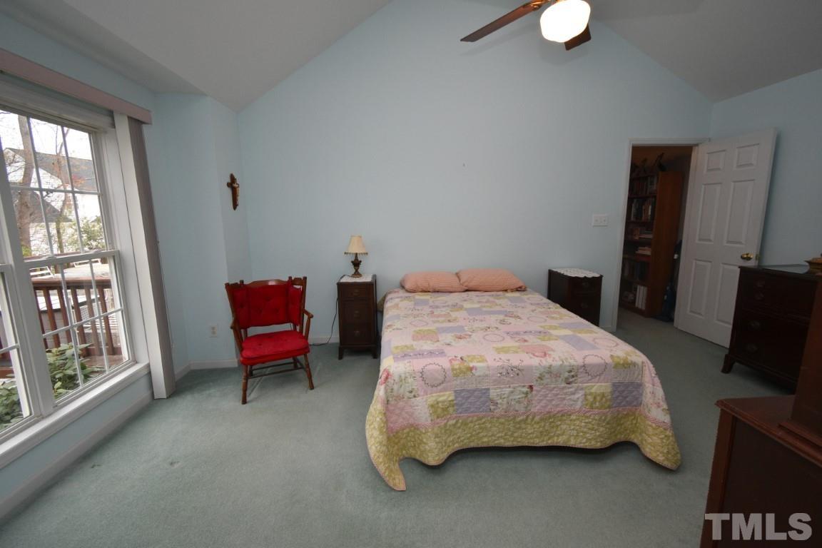 9904 Wyngate Ridge Drive Raleigh, NC 27617 - Photo 27 of 39 a bedroom with a bed chair and a window