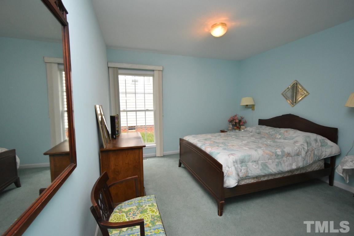 9904 Wyngate Ridge Drive Raleigh, NC 27617 - Photo 31 of 39 a bedroom with a bed window and chair