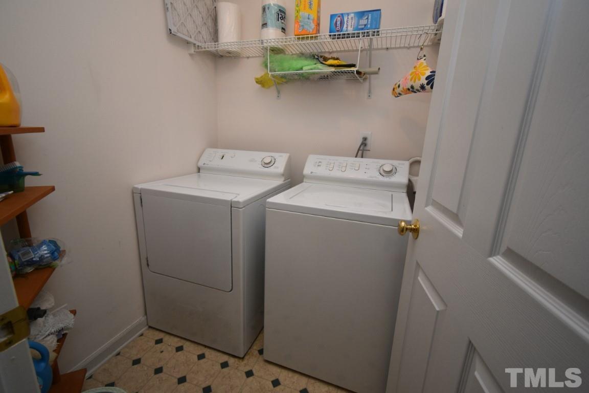 9904 Wyngate Ridge Drive Raleigh, NC 27617 - Photo 32 of 39 a utility room with dryer and washer