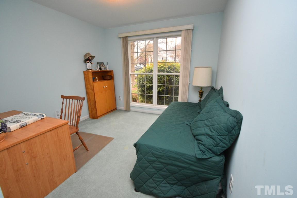 9904 Wyngate Ridge Drive Raleigh, NC 27617 - Photo 34 of 39 a bed sitting in a bedroom next to a window