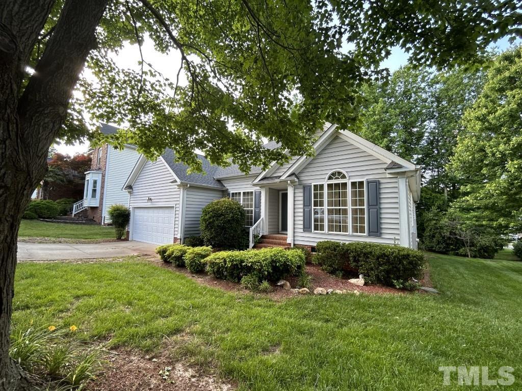 9904 Wyngate Ridge Drive Raleigh, NC 27617 - Photo 39 of 39 a front view of a house with a yard and garage