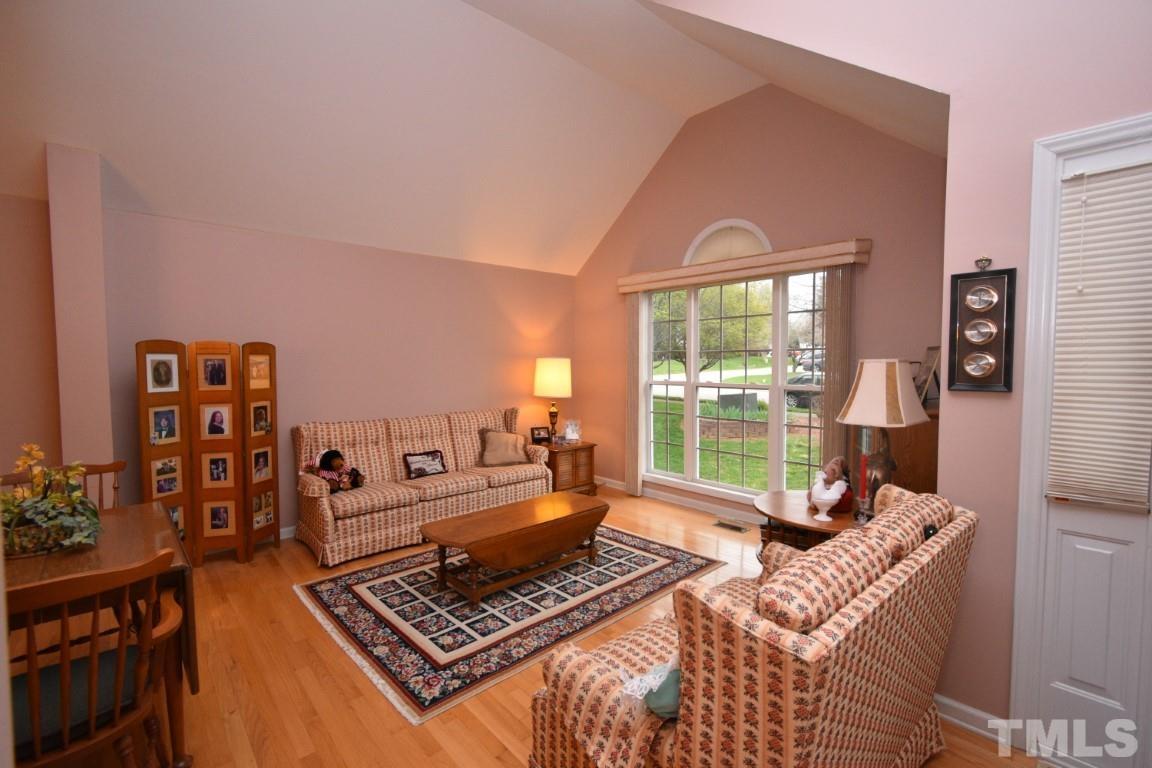 9904 Wyngate Ridge Drive Raleigh, NC 27617 - Photo 4 of 39 a living room with furniture large window and a table