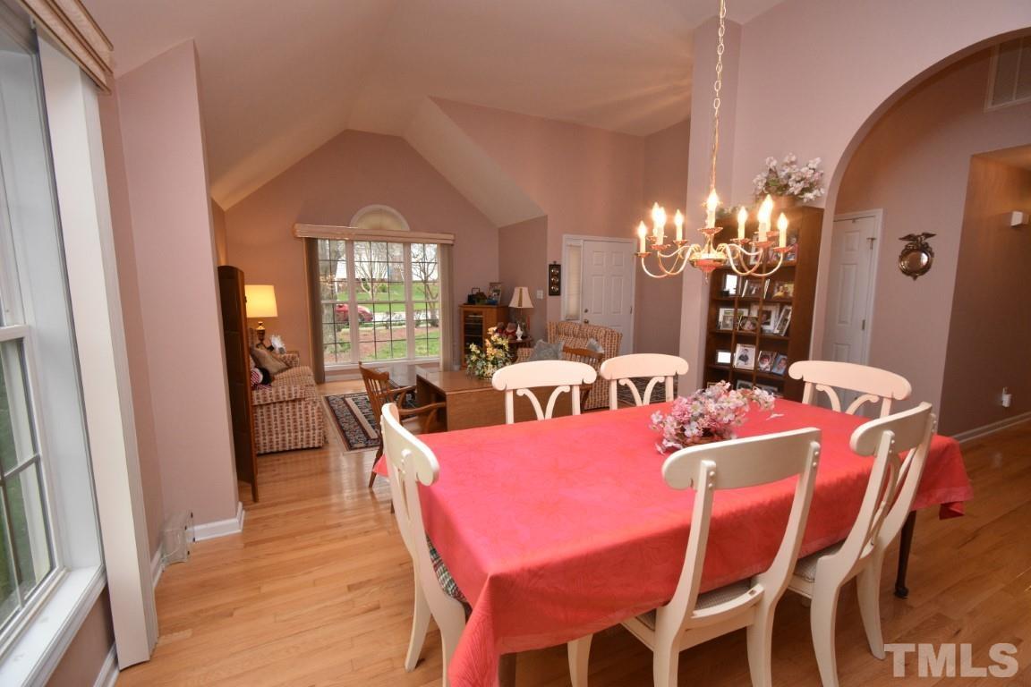 9904 Wyngate Ridge Drive Raleigh, NC 27617 - Photo 9 of 39 a view of a dining room with furniture and chandelier