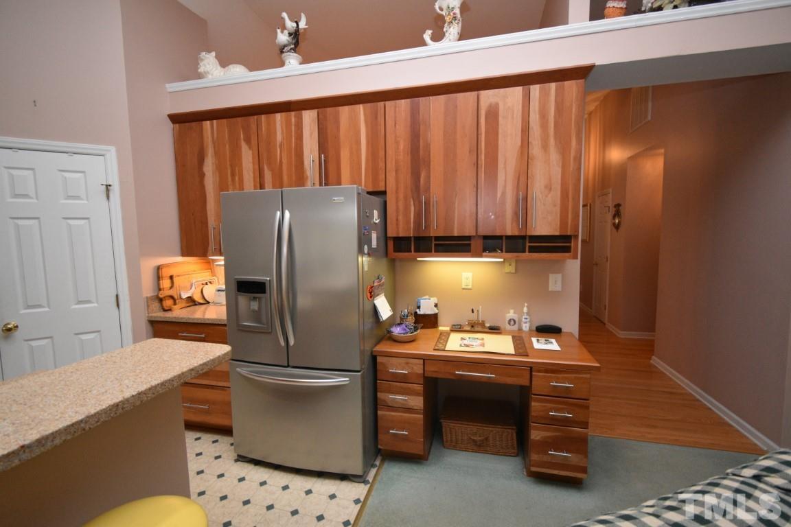 9904 Wyngate Ridge Drive Raleigh, NC 27617 - Photo 10 of 39 a kitchen with a refrigerator and cabinets