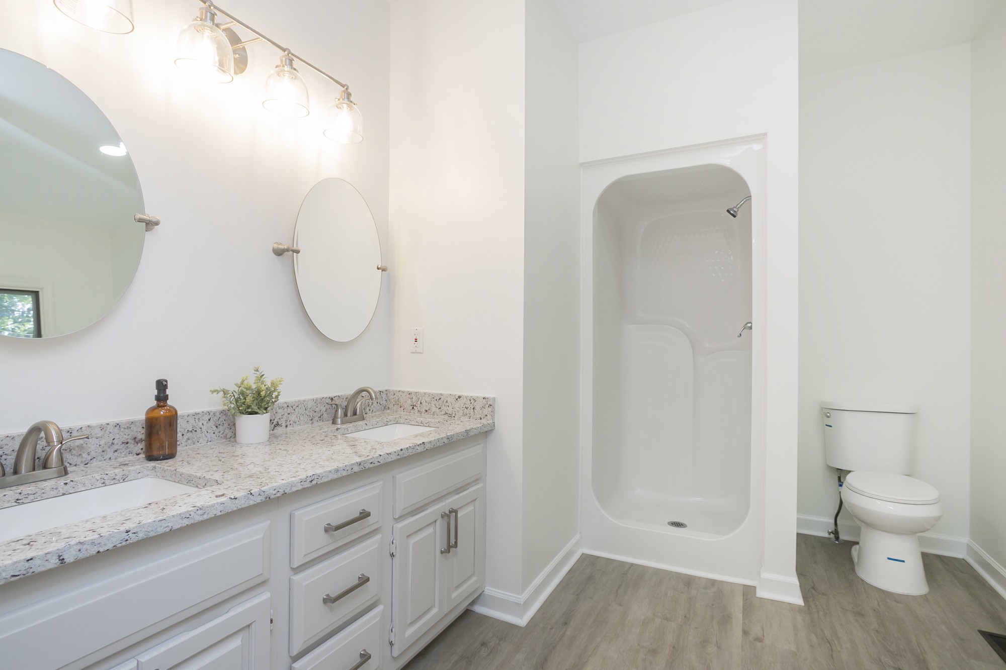 103 MacIntosh Drive Springfield, TN 37172 - Photo 12 of 20 a bathroom with a granite countertop sink a toilet and a mirror