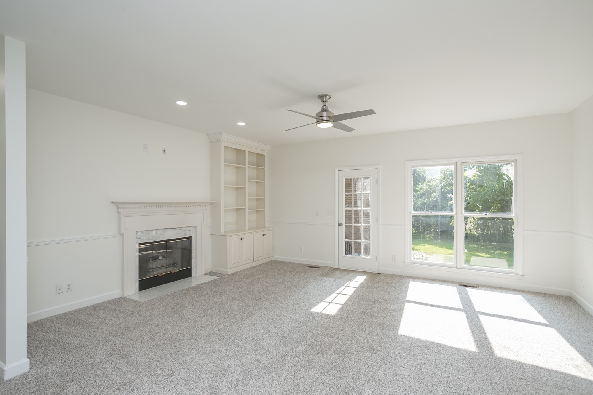 103 MacIntosh Drive Springfield, TN 37172 - Photo 6 of 20 an empty room with windows and fireplace
