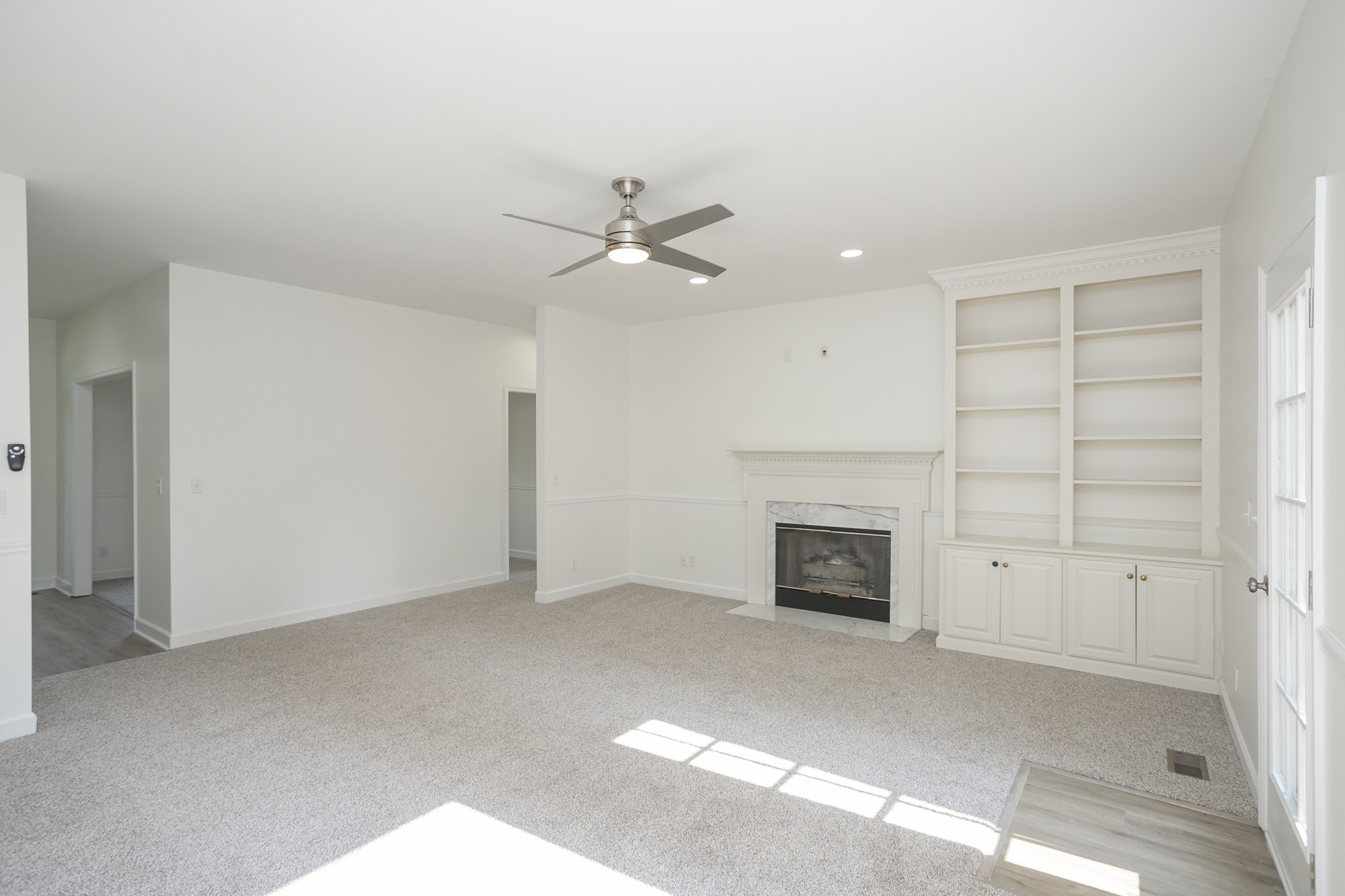 103 MacIntosh Drive Springfield, TN 37172 - Photo 7 of 20 an empty room with a fireplace and fan
