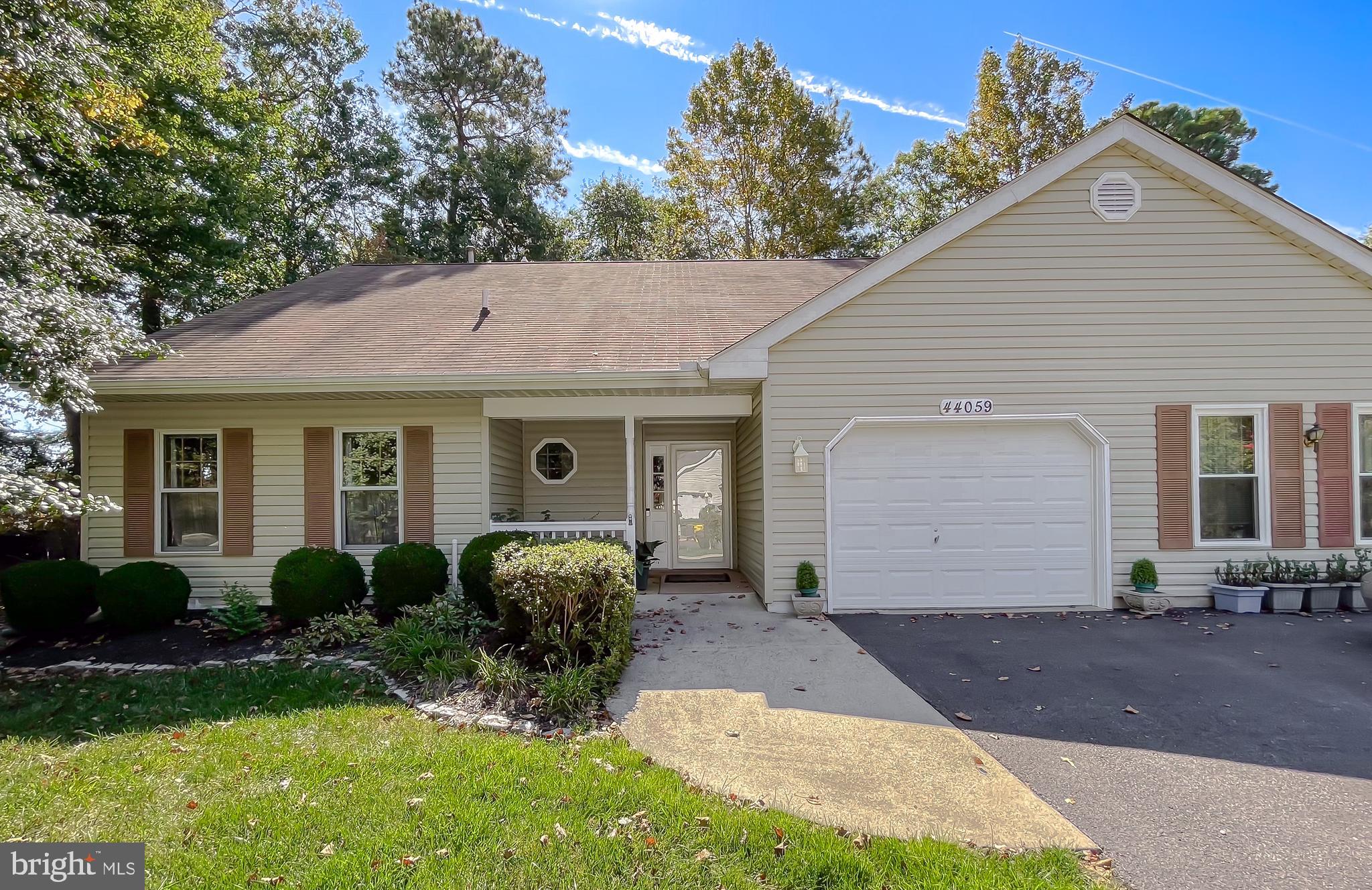 44059 Fieldstone Way California, MD 20619 - Photo 1 of 42 a front view of a house with garden