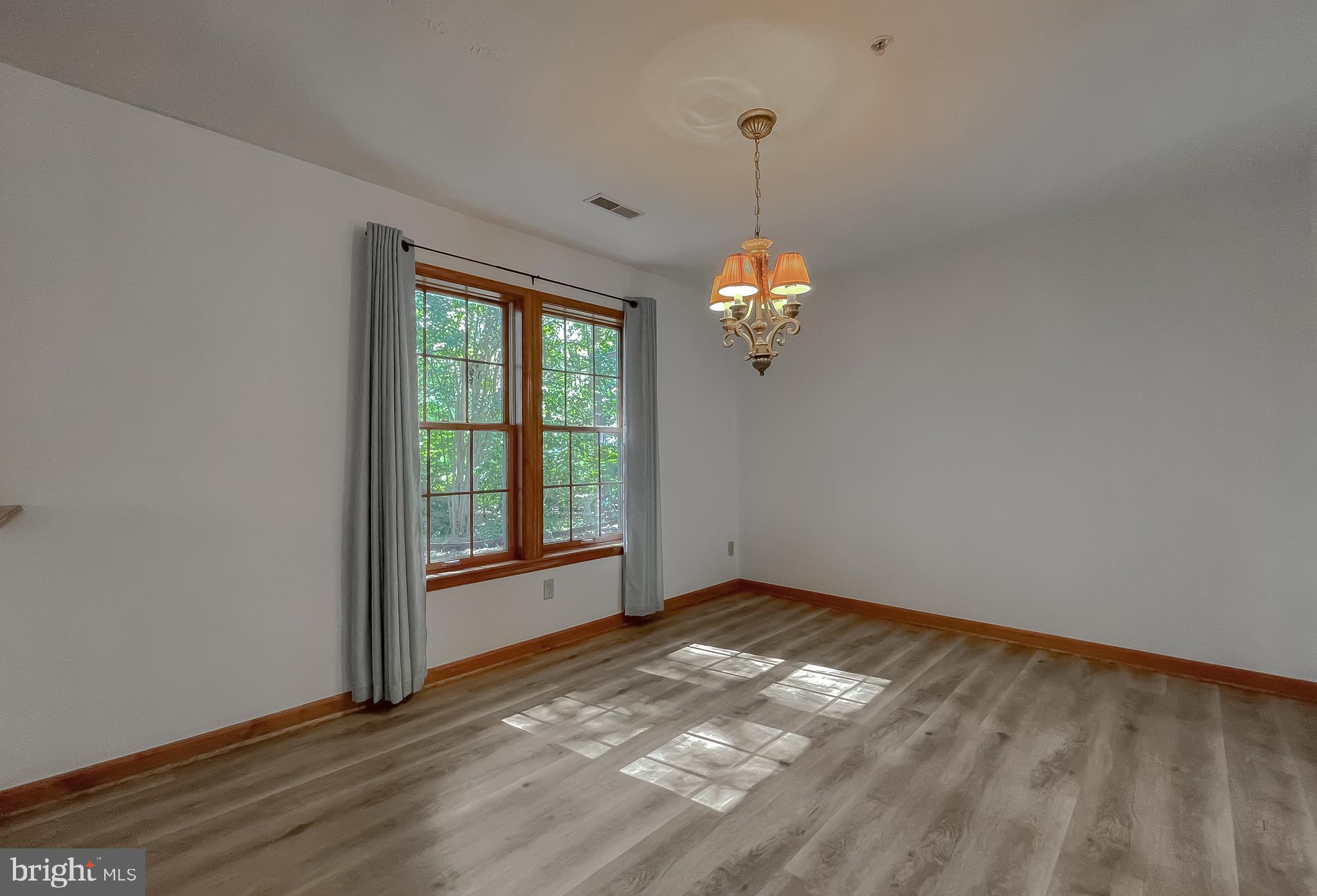 44059 Fieldstone Way California, MD 20619 - Photo 17 of 42 a view of an empty room with window and chandelier fan