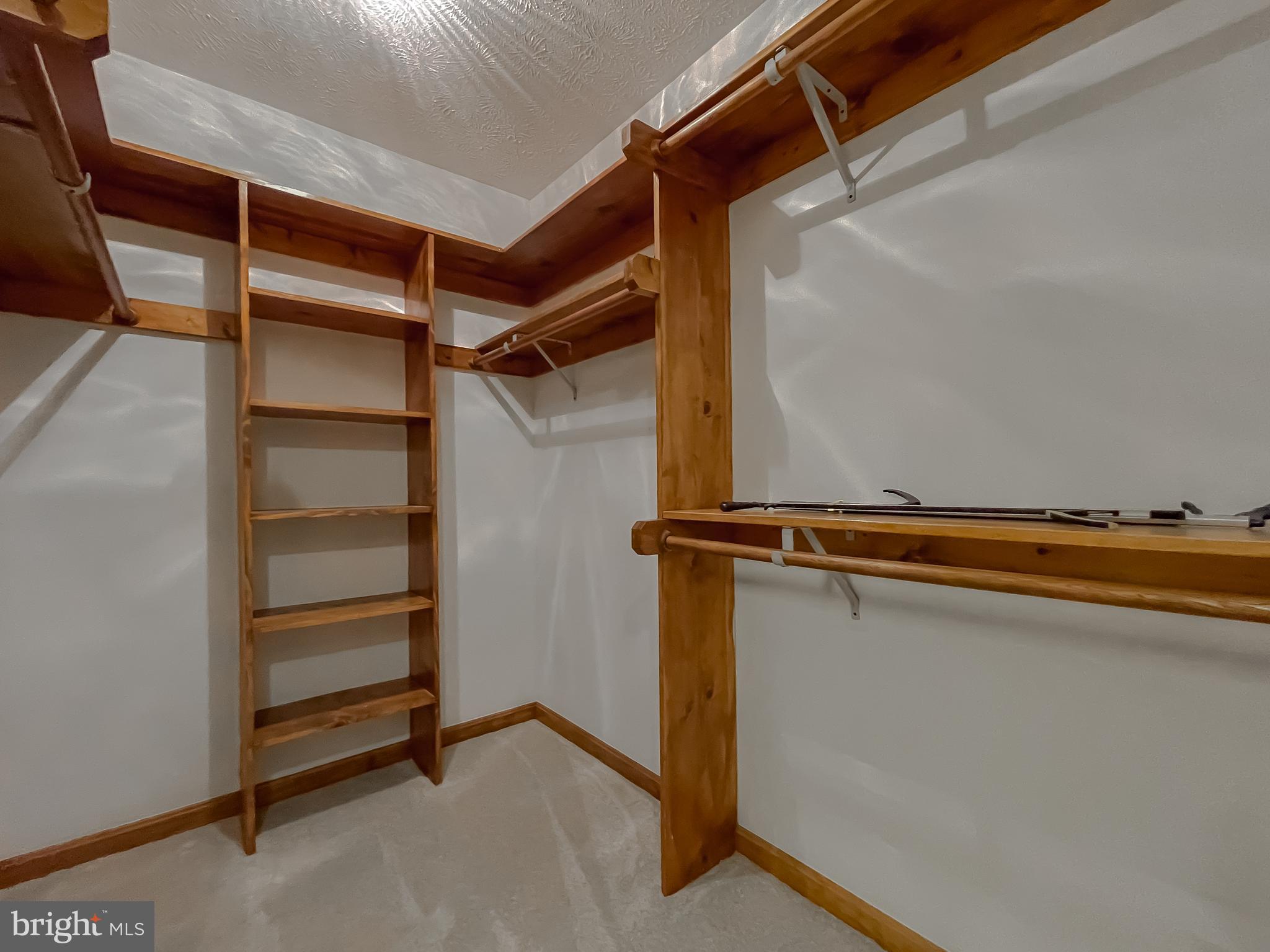 44059 Fieldstone Way California, MD 20619 - Photo 26 of 42 a view of walk in closet with empty racks