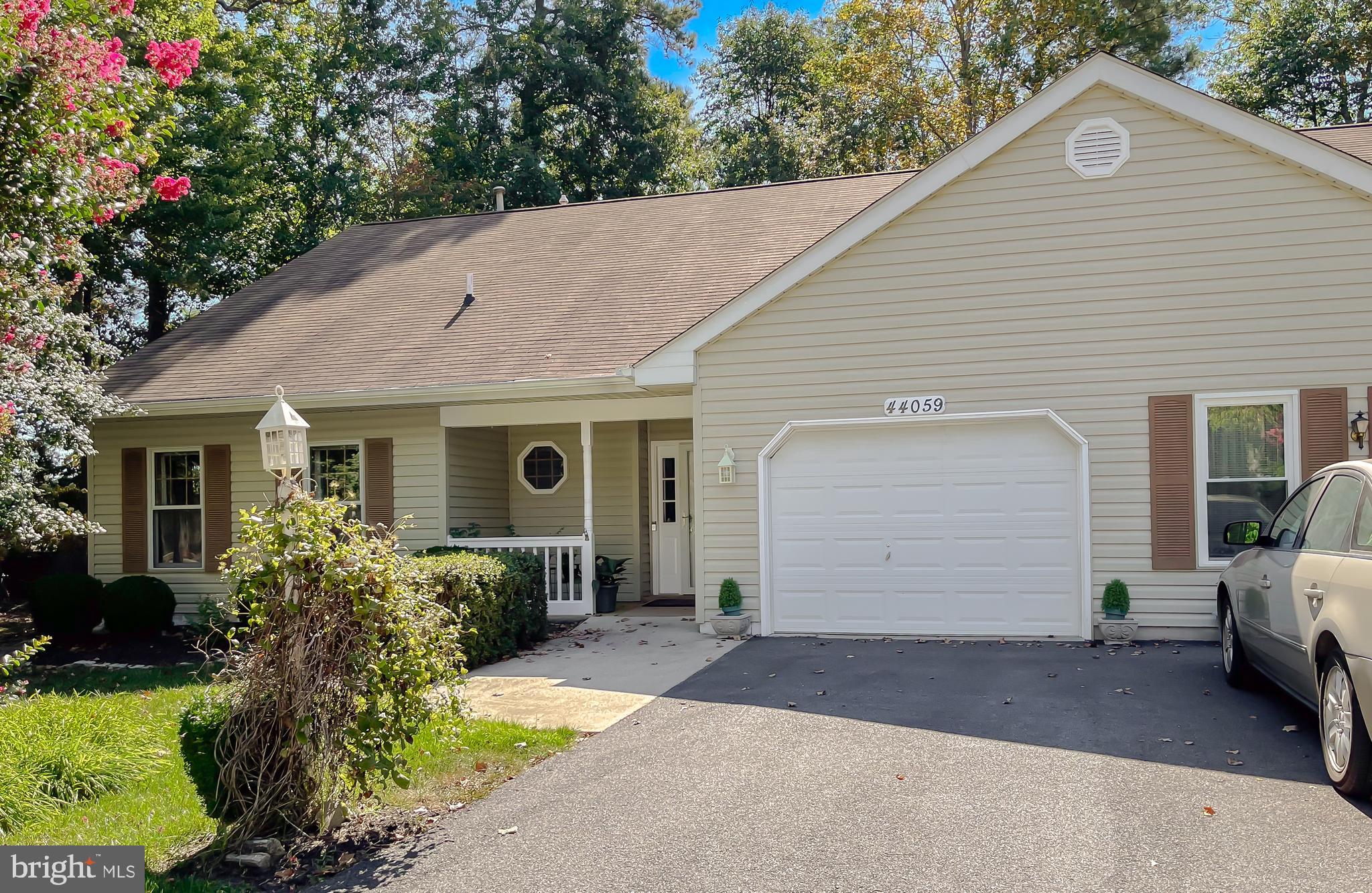 44059 Fieldstone Way California, MD 20619 - Photo 10 of 42 a front view of a house with a yard and garage